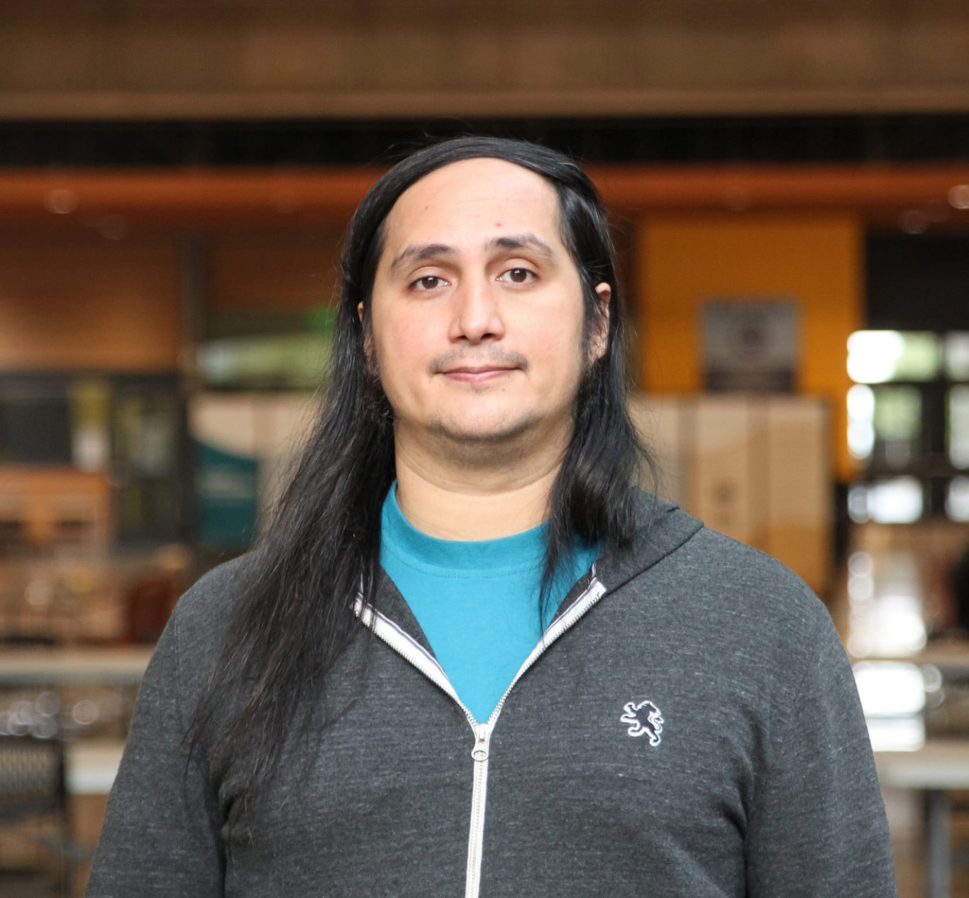Portrait of Heifara Wheeler, Food Assistance Coordinator at Pacific Climate Warriors Portland, standing outside. He shares a quote on the importance of food sovereignty and its connection to climate work and cultural identity.